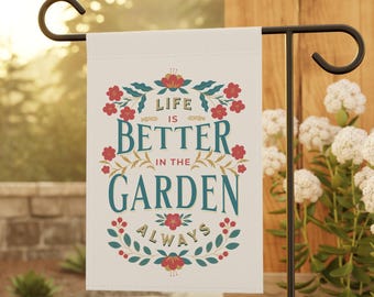 May include: A white garden flag with a floral design and the text "Life is better in the garden always".