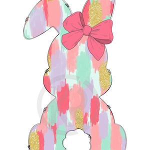 Puede incluir: Silueta de conejo en colores pastel con un lazo rosa, detalles de purpurina dorada y una cola blanca y esponjosa. El cuerpo del conejo está pintado con pinceladas rosas, moradas y verde menta. Diseño temático de Pascua.