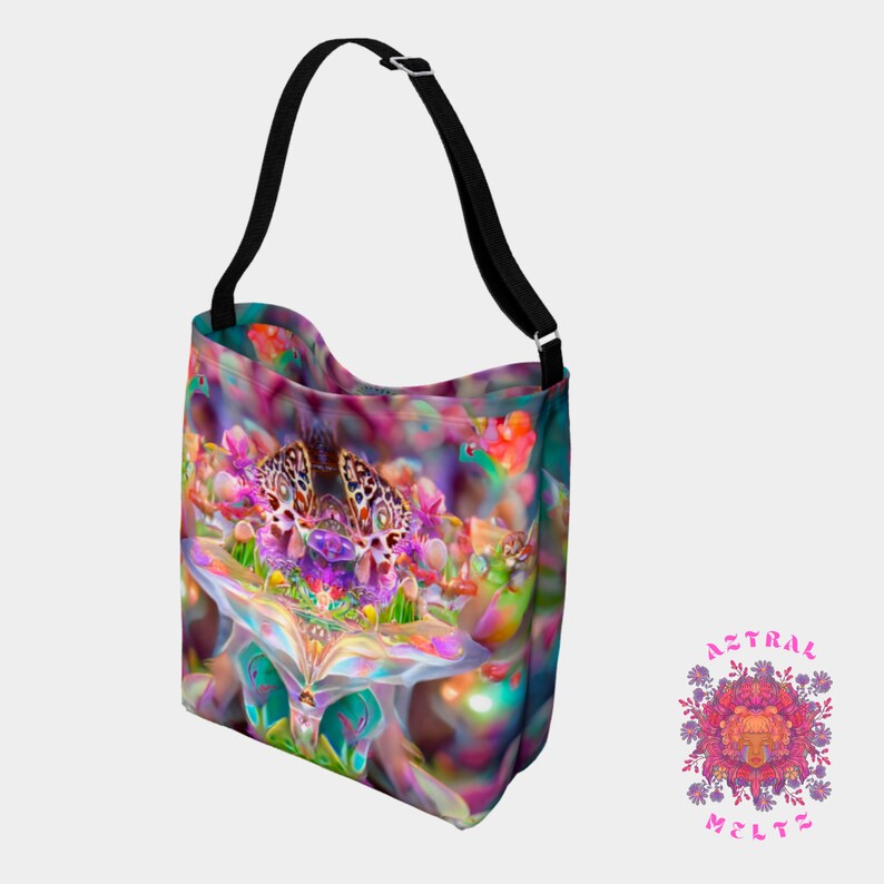 May include: A colorful tote bag with a psychedelic floral pattern and a black shoulder strap. The bag features a large, intricate flower design with butterflies and other floral elements. The bag is made of a durable canvas material and is perfect for carrying everyday essentials.