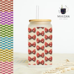 May include: A glass tumbler with a bamboo lid and a clear straw. The tumbler is decorated with a pattern of red bows with white polka dots. A vertical row of colourful bows is on the left.