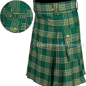 May include: A green, yellow, and white plaid kilt with a large cargo pocket on the right side. The kilt has a buckle closure and is made of a woven fabric.