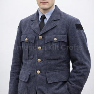 May include: A dark blue military-style jacket with gold buttons and multiple pockets. The jacket has a classic design with a collar and is worn over a light blue shirt and black tie. The text "American Kilt Crafts" is visible.
