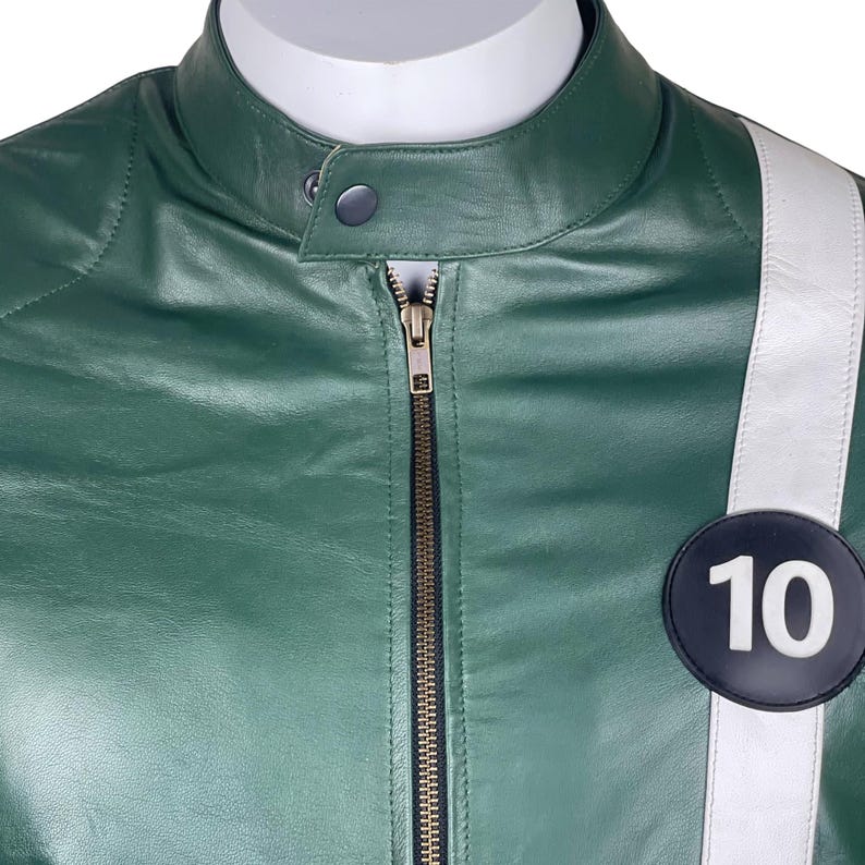 May include: A green leather jacket with a white stripe and a black circle with the number 10 on it.