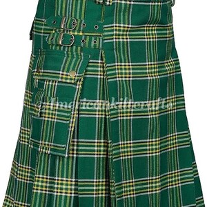 May include: A green and yellow plaid kilt with a large cargo pocket on the front. The kilt has a belt with buckles and is pleated.