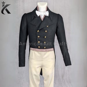 May include: A black tailcoat with gold buttons and a pink sash. The tailcoat has a long, flowing tail and is worn over a white shirt with a bow tie. The text "American Kilt Crafts" is visible on the image.