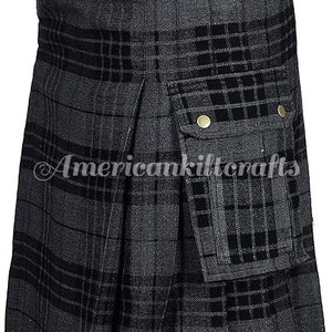 May include: A black and gray plaid kilt with a large cargo pocket on the front. The kilt has a black waistband with two brass buttons.