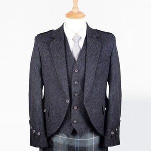 May include: A dark grey tweed jacket with a matching waistcoat and a kilt. The jacket has a single-breasted closure and a notched lapel. The waistcoat has a five-button closure and a pointed collar. The kilt is a traditional Scottish kilt with a plaid pattern.