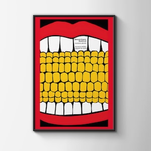 May include: A framed poster with a bold, graphic design. The artwork features a red mouth with white teeth, framing a yellow corn cob. The poster includes the text "Sweet Corn Festival summer picnic herman miller august 21, 1970" in a white rectangle.