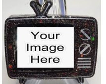 May include: Black glitter retro TV ornament with a blank screen that says "Your Image Here".