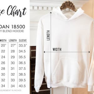 May include: White Gildan 18500 heavy blend hoodie with a size chart. The chart shows measurements in inches, equivalent to cm, for width, length, and sleeve length, ranging from size S to 5XL. The hoodie is on a hanger.