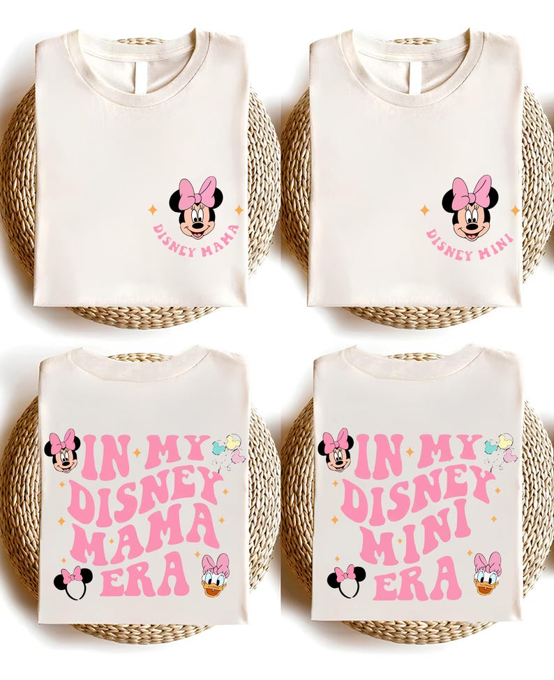 May include: Two white t-shirts with a pink Minnie Mouse design. One shirt says "Disney Mama" and the other says "Disney Mini". The bottom two shirts are the same design but say "In My Disney Mama Era" and "In My Disney Mini Era".