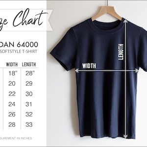 May include: A navy blue Gildan 64000 Softstyle T-shirt hangs on a wooden hanger. The image includes a size chart with measurements in inches, equivalent to cm: S (45.7cm width, 71.1cm length), M (50.8cm width, 73.7cm length), L (55.9cm width, 76.2cm length), XL (61cm width, 78.7cm length), 2XL (66cm width, 81.3cm length), and 3XL (71.1cm width, 83.8cm length).