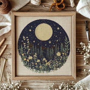 May include: A cross-stitch pattern featuring a full moon, stars, and a forest scene with flowers. The design is circular and has a dark blue background.