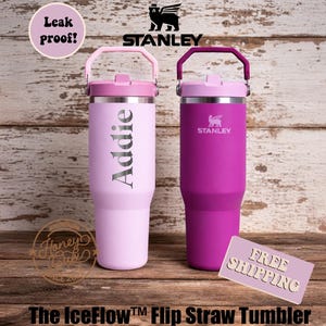 May include: Two Stanley IceFlow Flip Straw Tumblers, one light pink with "Addie" and the other magenta. Both have pink handles and lids. The image includes the Stanley logo, "Leak Proof!" text, and "The IceFlow Flip Straw Tumbler" text.