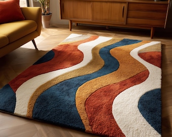 May include: A rectangular area rug with a retro design. The rug features a wavy pattern in shades of blue, orange, yellow, and white. The rug is placed on a wooden floor, and the overall aesthetic is mid-century modern.