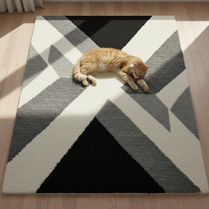 May include: A geometric rug with a pattern of black, white, and grey shapes. The rug has a repeating design of angled lines and triangles. An orange tabby cat is lying on the rug.