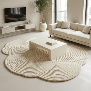 Contemporary handmade tufted rug with carved wave texture and neutral cream tones for Scandinavian and Japandi interiors