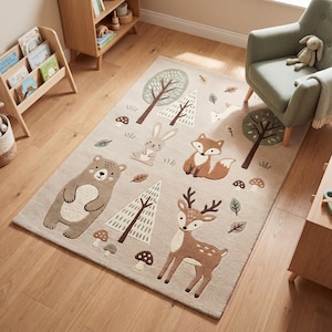 May include: A rectangular beige area rug with a woodland animal design. The rug features a bear, rabbit, fox, and deer, along with trees, mushrooms, and leaves. The rug is placed on a hardwood floor.