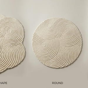 May include: Three off-white rugs featuring a textured, concentric circular pattern. The left rug has an irregular organic shape labeled MAIN SHAPE, the center rug is circular labeled ROUND, and the right rug is rectangular labeled RUNNER.