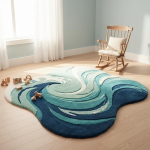 May include: A plush, wave-shaped rug in shades of blue and white. The rug has a soft, textured surface and a unique, organic shape. Wooden toy blocks are scattered nearby. A wooden rocking chair with a cream-colored cushion sits in the background.