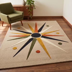 May include: A rectangular area rug featuring a central dark circle surrounded by radiating pointed rays in shades of orange, yellow, dark blue, olive green, and cream, accented with small solid circles in matching colours on a beige background.