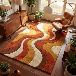 May include: A retro-style area rug with a wavy pattern in shades of orange, brown, yellow, and cream. The rug is placed on a hardwood floor, and the room is decorated in a mid-century modern style.