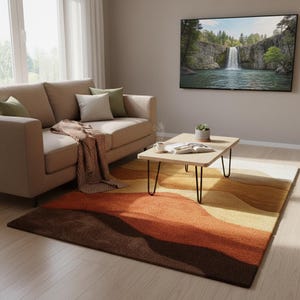 May include: A living room scene featuring a beige sofa with throw pillows and a brown blanket. A wooden coffee table with black hairpin legs sits on a colorful rug with shades of brown, orange, and yellow. A large TV displays a waterfall scene.