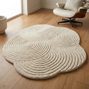 Luxury ivory wool blend rug featuring organic contour pattern and minimalist irregular silhouette for bedroom or lounge styling