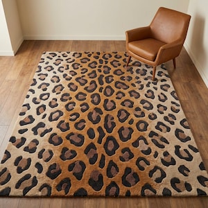 May include: A rectangular area rug with a leopard print design. The rug features a gradient of colors, transitioning from a light tan to a dark brown. The leopard spots are in shades of brown and black. A brown leather armchair is in the background.