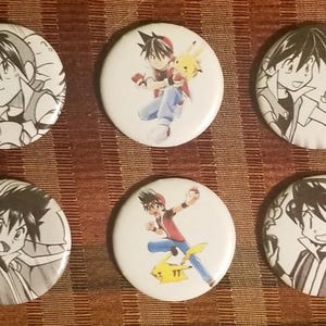 May include: Set of six white round buttons featuring anime-style illustrations. The buttons showcase various characters in action poses, with some accompanied by a yellow creature. The artwork is in a mix of color and black and white.