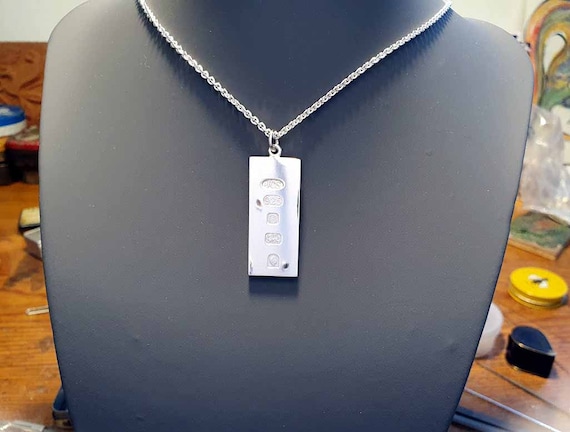 Silver Hallmark ingot pendant featuring the speci… - image 1