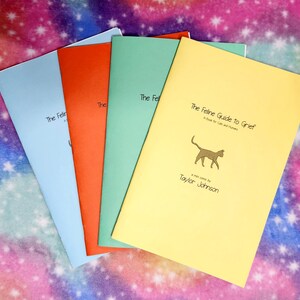 May include: Four books with colorful covers: light blue, orange, green, and yellow. The yellow book is titled "The Feline Guide to Grief" with a cat illustration and author's name. The other books have the title "The Feline..." on the cover.
