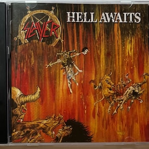May include: A CD case with a red and black Slayer logo and the album title "Hell Awaits" in white text. The cover art features a demonic scene with a red and orange background.