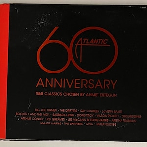 May include: A black CD case with a red spine. The cover features a large orange "60" and the word "ANNIVERSARY" below it. The text "R&B CLASSICS CHOSEN BY AHMET ERTEGUN" is also visible. The Atlantic Records logo is in the center.