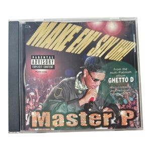 May include: A Master P music CD in a clear plastic jewel case. The cover features the artist holding a microphone, with the text 'MAKE 'EM SAY UHH!', 'Master P', 'Parental Advisory Explicit Content', and 'From the Multi-Platinum album GHETTO D'.