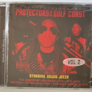 May include: A CD cover with a red and black color scheme. The title is "Protectors of the Gulf Coast" with the text "Vol 2" in a white circle. The text "Starring Young Jeezy" is below the title. The cover features a man wearing sunglasses and a black shirt.