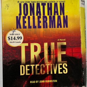 May include: Book cover for the novel "True Detectives" by Jonathan Kellerman, a #1 New York Times bestselling author. The cover features a cityscape with a silhouette of a person walking on a rooftop. The book is read by John Rubinstein. The price is $14.99.