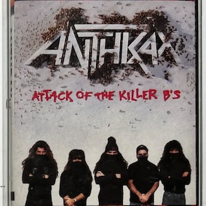 May include: A cassette tape with a black and white image of a band called "Anthrax" on the front. The band members are wearing black clothing and have their faces covered. The text "Attack of the Killer B's" is printed in red below the band name.