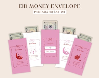 May include: Pink and white Eid money envelopes with decorative red borders and illustrations. Each envelope contains cash. Text on the envelopes includes "Eid Mubarak" and "Happy Eid!" with space for "To" and "From" names.