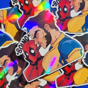 May include: A collection of stickers featuring comic book characters. The stickers depict Wolverine and Deadpool, both smoking cigars. The stickers have a holographic finish, with blue, yellow, and red colors. The word "BOING" is visible on one sticker.
