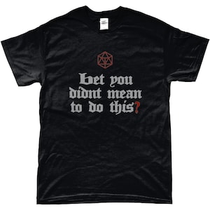Pode incluir: Camiseta preta com um gráfico branco de um dado de 20 faces e o texto "Bet you didn't mean to do this?"