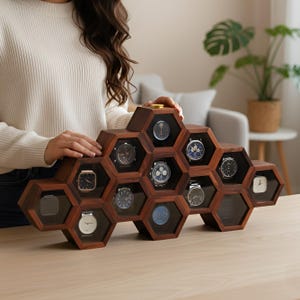 May include: A dark brown wooden display case featuring a honeycomb structure with multiple hexagonal compartments. Each compartment contains a wristwatch with a unique face and dial design. The display case is arranged in a tiered, geometric pattern.