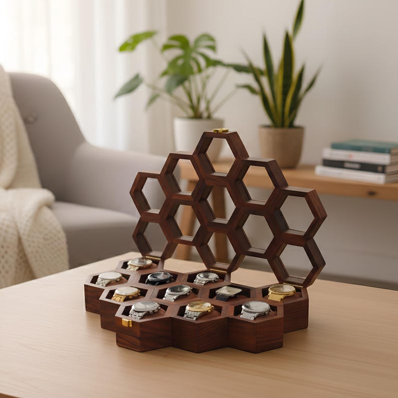 May include: A dark brown wooden watch display case featuring a honeycomb-inspired design with multiple hexagonal compartments. The open lid reveals a geometric structure, while the base holds several wristwatches with metallic bands.
