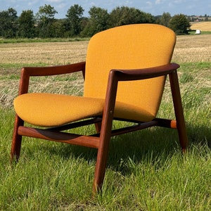Danish mid century lounge chair, newly reupholstered in a top quality fabric & teak frame in very good condition, in the style of Finn Juhl