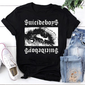 May include: Black t-shirt with a white graphic of an eye and the text "$uicideboy$  $uicideboy$"