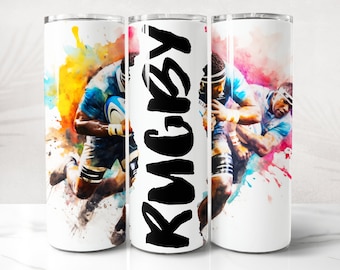 May include: Two rugby players in blue jerseys with a watercolor background. The word "RUGBY" is written in black on the side of the tumbler.