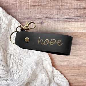 Black leather keychain with gold lettering &quot;hope&quot;
