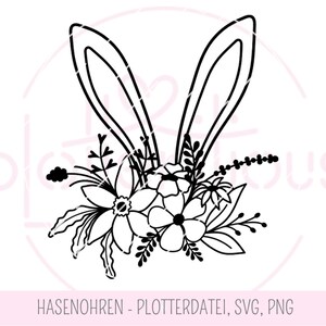 Op de afbeelding: Zwart-witte silhouet van konijnenoren met een bloemstuk van bloemen en bladeren.