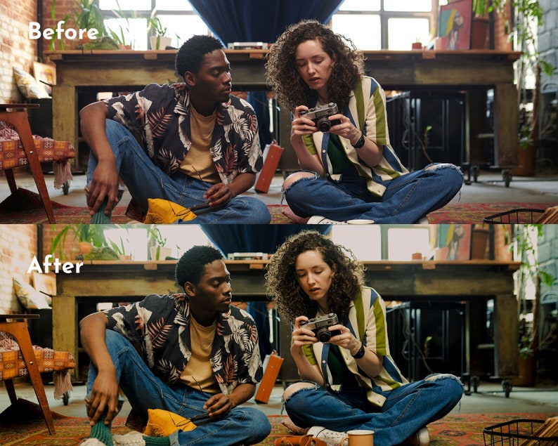 May include: Two people are sitting on a rug, one holding a vintage camera. They are wearing casual clothing, including a striped shirt, a floral shirt, and ripped jeans. The scene is set in a room with a large wooden table and artwork.