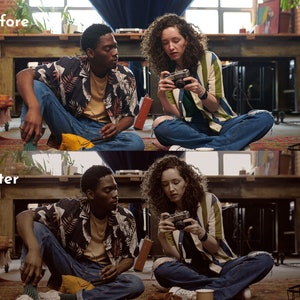 May include: Two people are sitting on the floor, one holding a camera. The person on the left is wearing a black and white patterned shirt and blue jeans. The person on the right is wearing a striped shirt and ripped blue jeans. A vintage camera is in focus.
